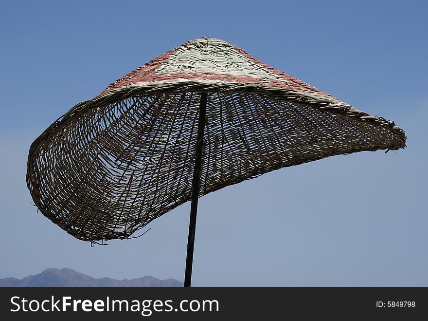 Beach umbrella under blue sky. Beach umbrella under blue sky