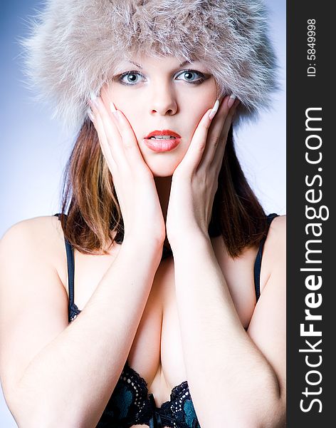 Sensual girl in fur hat studio shot