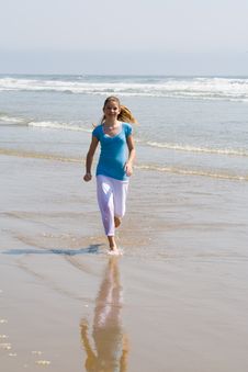 Teen Girl Running In The Surf Stock Images