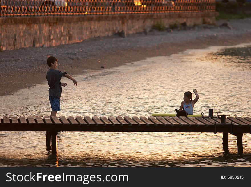 Boy and girl playing together in the lake