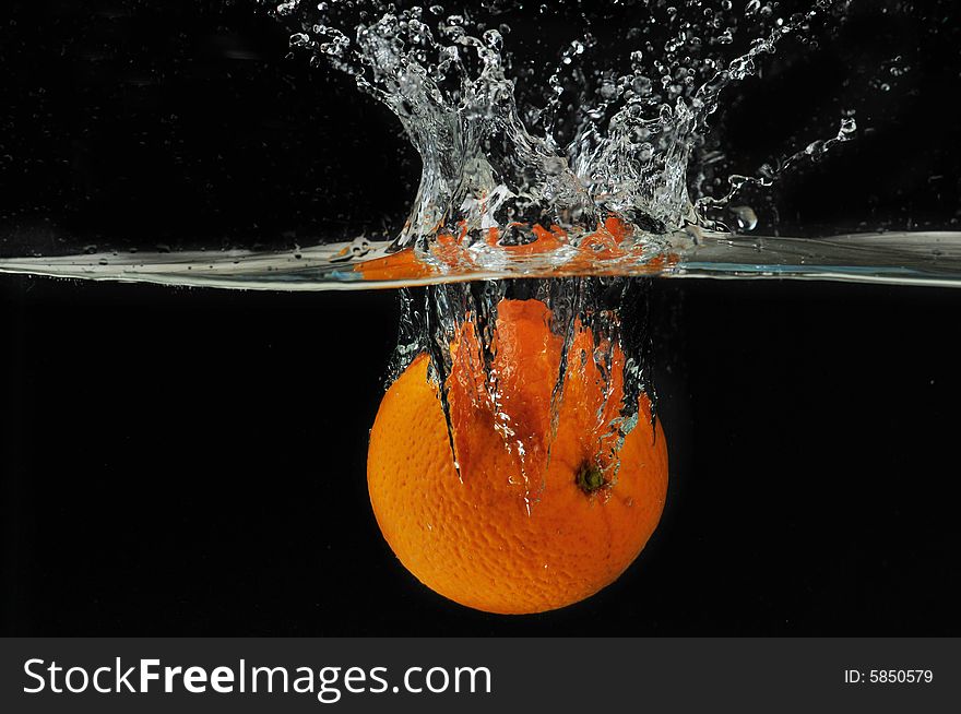 Splashing Orange Into A Water