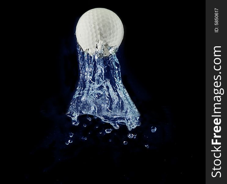 Splashing golf ball into a water in black