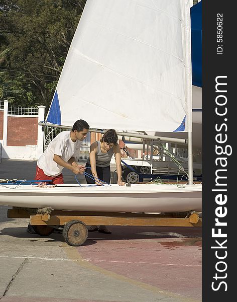 Couple preparing to sail - Vertical