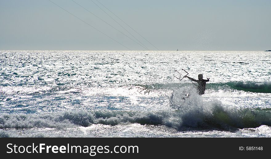 Kitesurfer jumping a wave in summer by a windy day. Kitesurfer jumping a wave in summer by a windy day