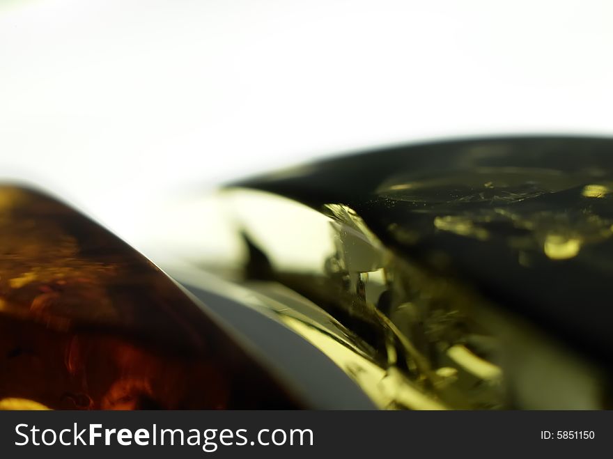 Extreme closeup of amber jewelry, natural particles on surface, shallow DOF. Extreme closeup of amber jewelry, natural particles on surface, shallow DOF