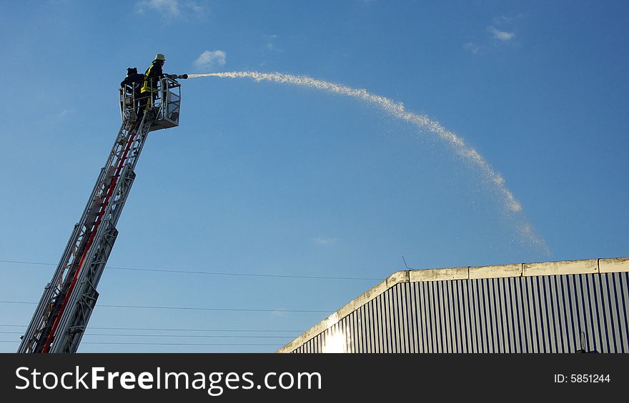 Two fire Fighters using an Aerial Ladder