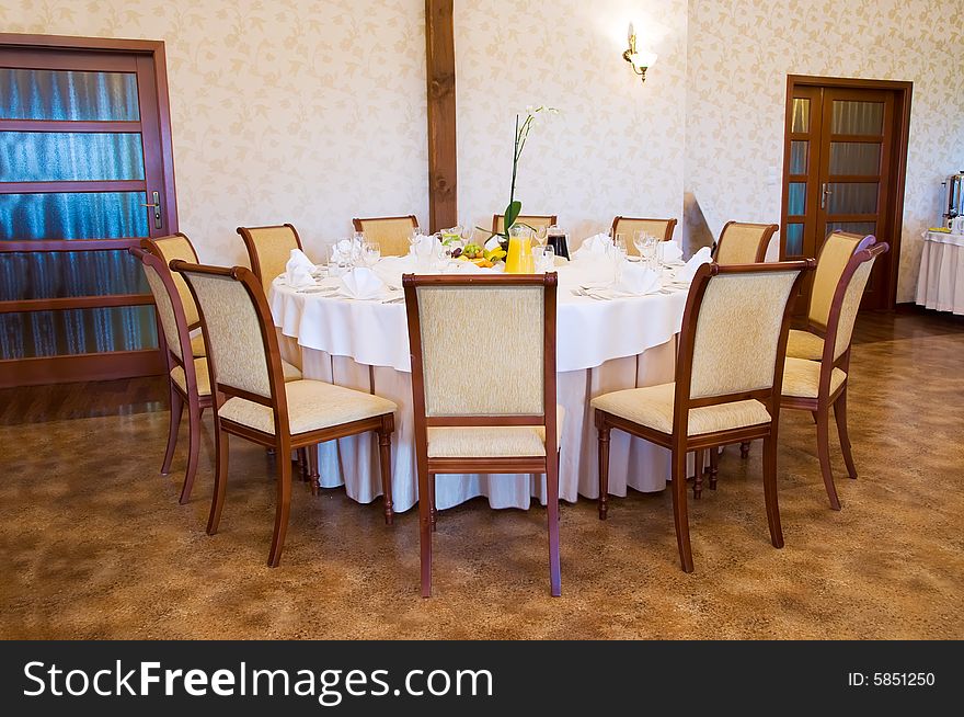 Round banquet table with chairs by door. Round banquet table with chairs by door