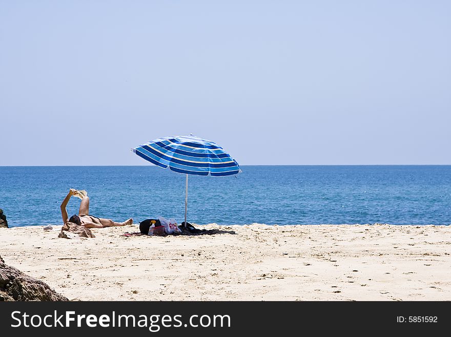 Man Reading In The Beach