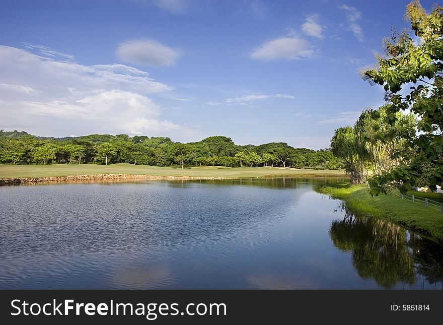 A lake on the edge of a tropical golf course. A lake on the edge of a tropical golf course