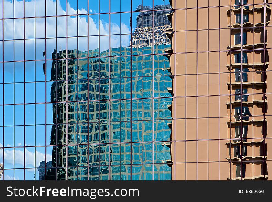 Buildings Reflecting In A Skyscraper