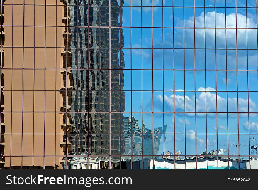 Buildings reflecting in a skyscraper