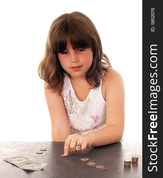 An elementary girl counting her pennies and quarters and dollar. An elementary girl counting her pennies and quarters and dollar.