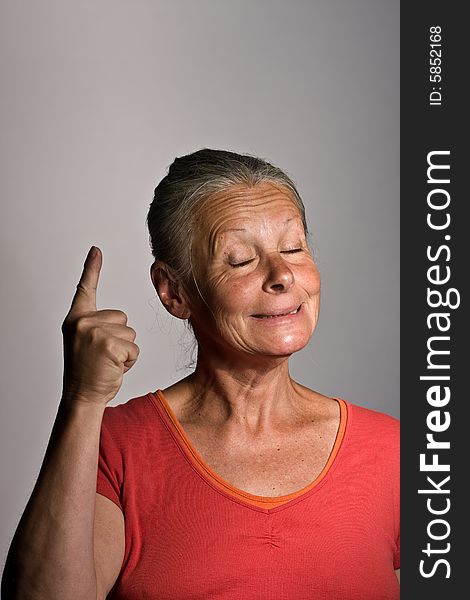 Portrait of senior woman against grey background. Portrait of senior woman against grey background