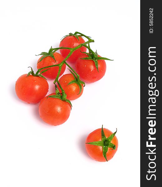 Cherry tomatoes together and one of that is alone, on a white background