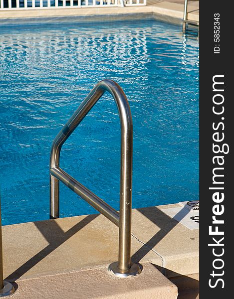 A Ladder Leading Into A Bright Blue Pool