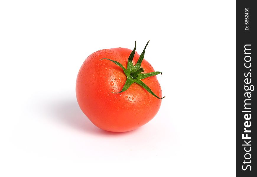 Tomato alone and wet on a white background. Tomato alone and wet on a white background