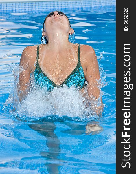 A beautiful woman relaxing in the pool.