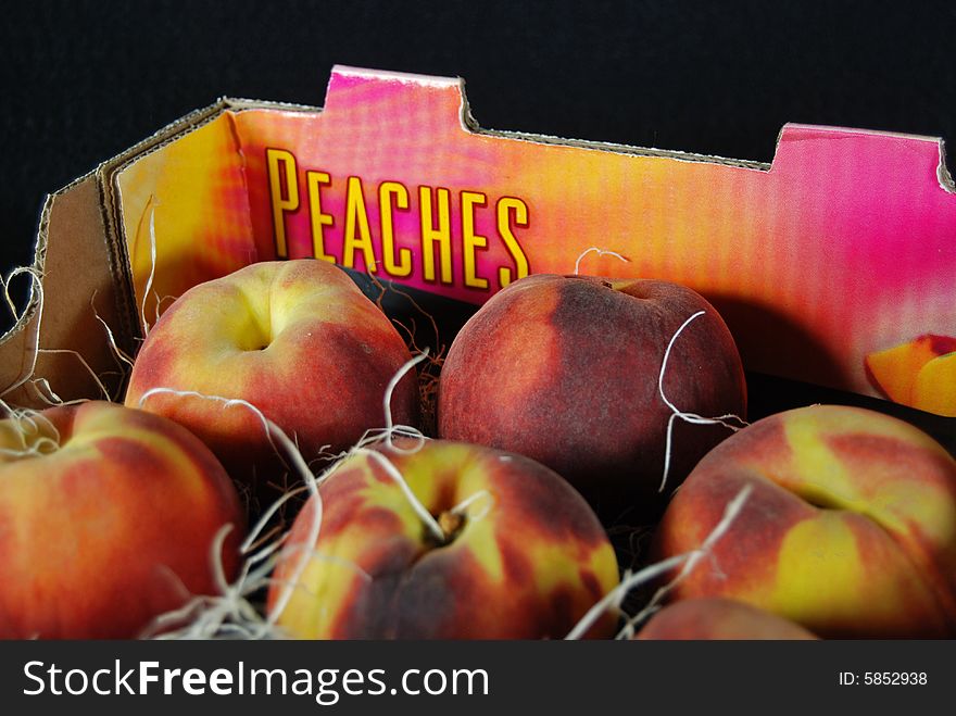 Fresh peaches shipped in a cardboard box. Fresh peaches shipped in a cardboard box.