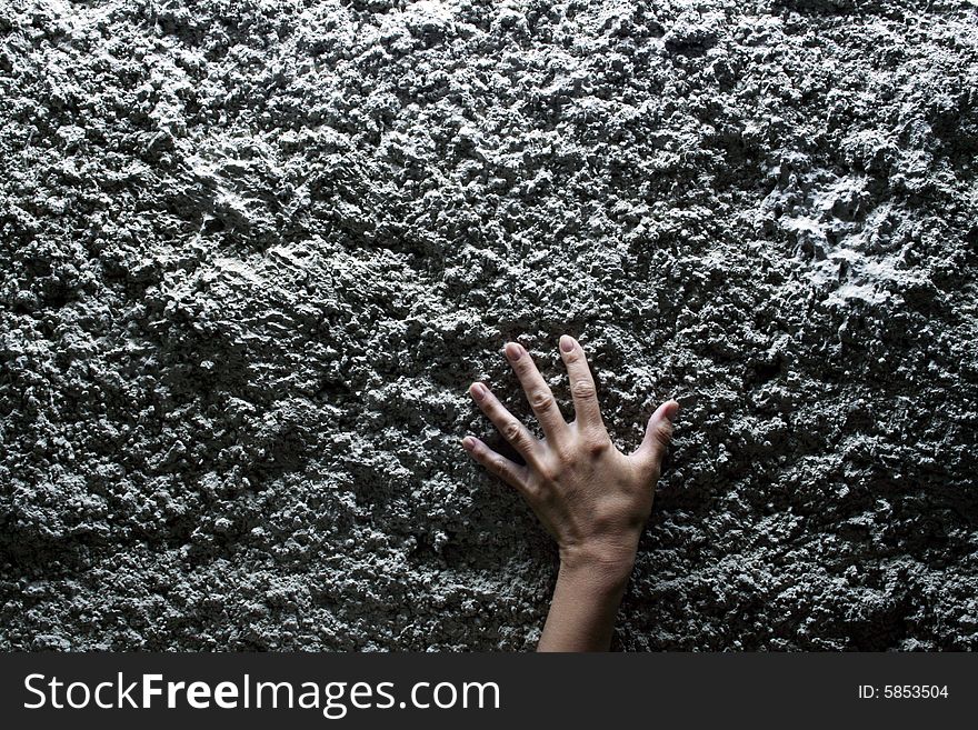 Nice female hand lying on gray stone background. Nice female hand lying on gray stone background