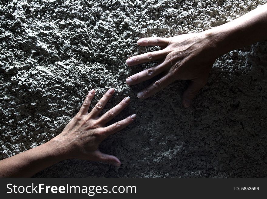 Two hands lying on gray stone background. Two hands lying on gray stone background