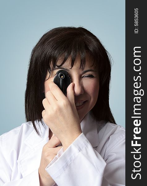 A female optician turning the wheel dial of an opthalmoscope. closeup. A female optician turning the wheel dial of an opthalmoscope. closeup.