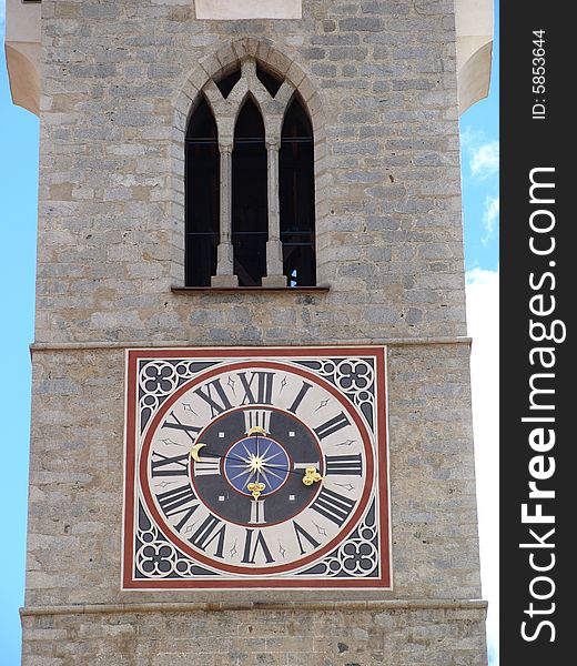 Details of the clock and the window of the Bressanone belltower. Details of the clock and the window of the Bressanone belltower