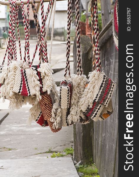 Traditional Romanian bags made of wool.They are hung on the home's wooden fences in the street for selling.They are characteristic for a certain part of Transylvania called Oasului Country.