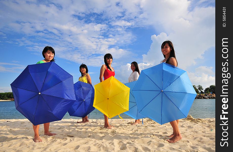 Girls on the beach with umbrellas. Girls on the beach with umbrellas.