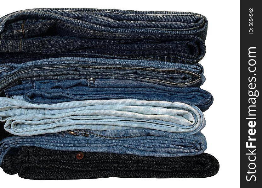 Stack of blue and black jeans over white with clipping path. Stack of blue and black jeans over white with clipping path
