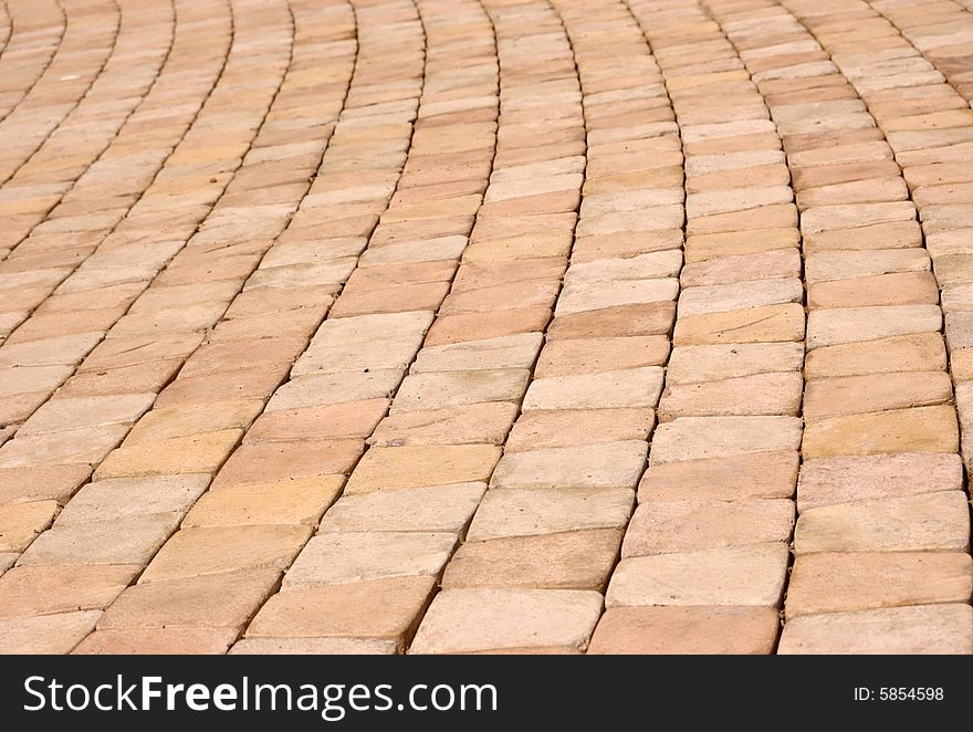 Close-up of new old-style pavement of stoneblocks (bricks) of warm color