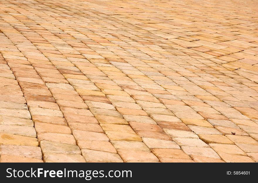 Close-up of new old-style pavement of stoneblocks (bricks) of warm color