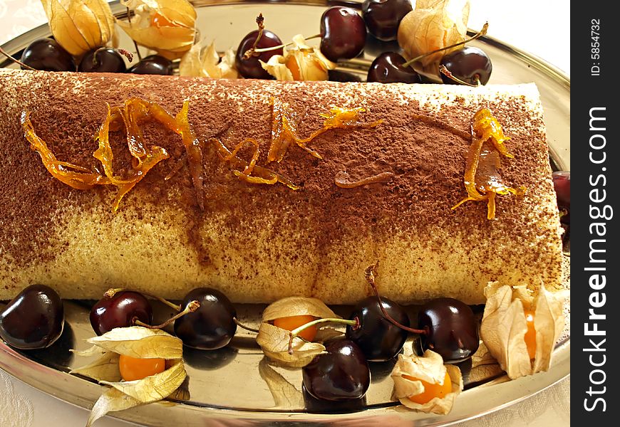 Cake with cherries chocolate and sugared oranges peel