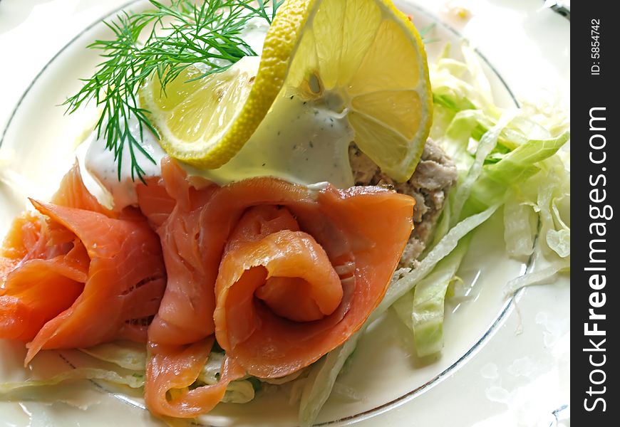 Fresh smoked salmon served with sauce and dill. Fresh smoked salmon served with sauce and dill