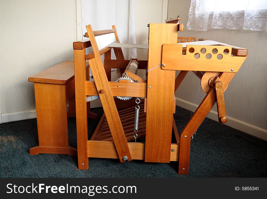 An old weaving loom viewed side on. An old weaving loom viewed side on