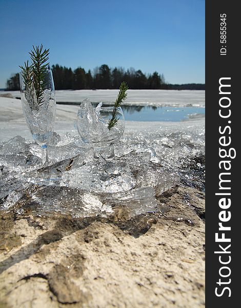 Glasses with ice on the edge of a frozen lake
