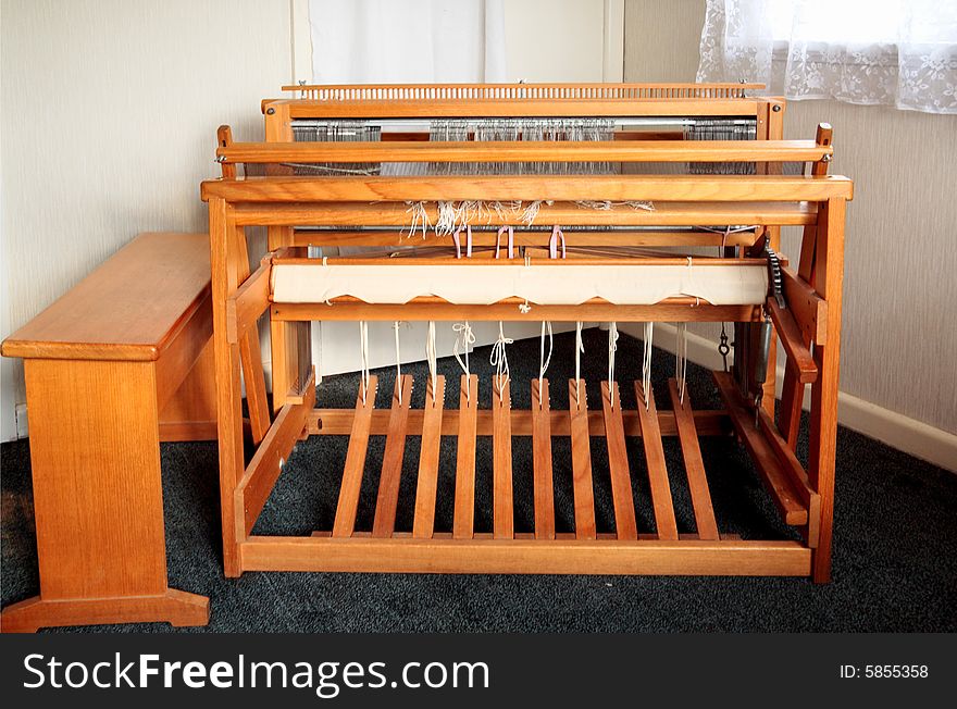 An old weaving loom shot from the users side, with the bench moved to allow a view of the pedals. An old weaving loom shot from the users side, with the bench moved to allow a view of the pedals