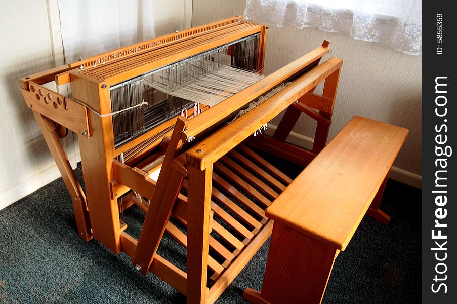 A view of an old weaving loom from the top and side