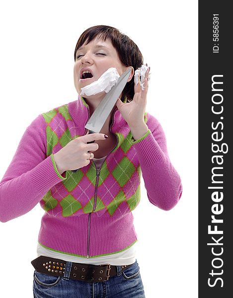 Young woman with knife and foam on her face