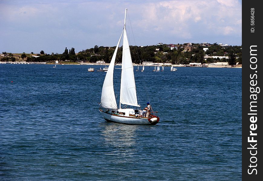 Beautiful sailing yacht with two people abord. Beautiful sailing yacht with two people abord