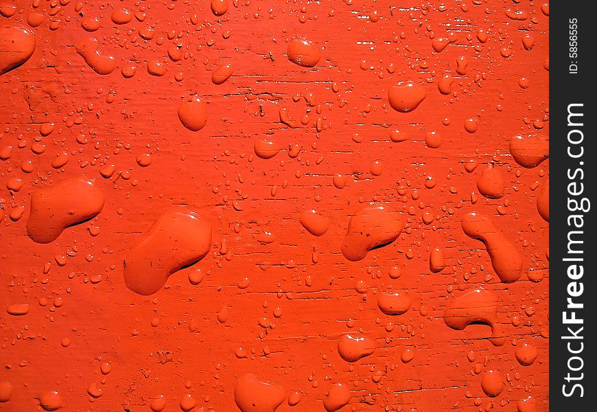 Water drops on red surface.