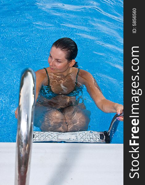 A beautiful woman relaxing in the pool.