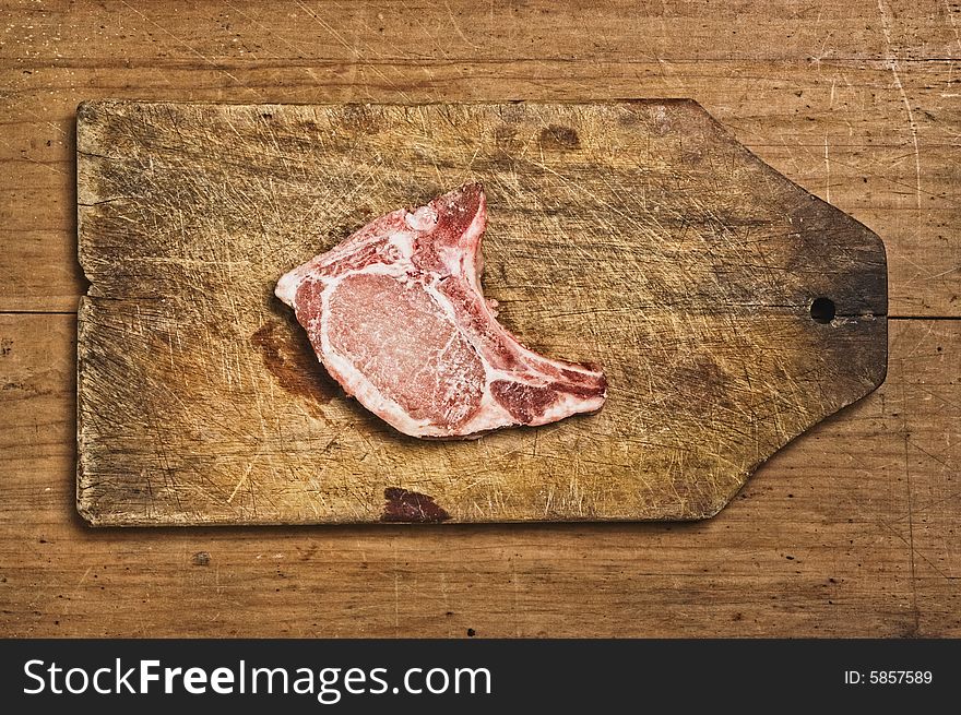 Raw Pork Chop isolated on cutting table. Studio shot. Raw Pork Chop isolated on cutting table. Studio shot.