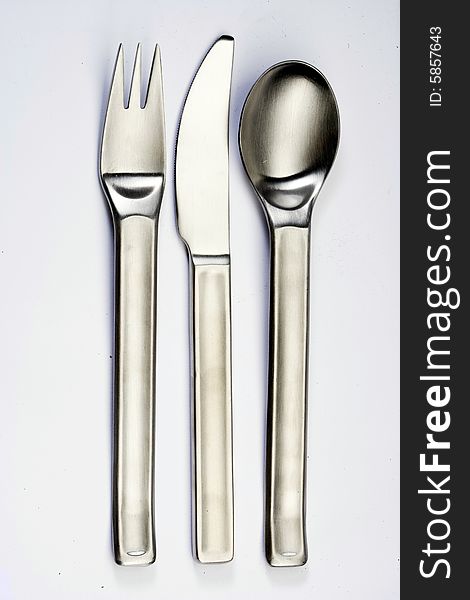 Fork, knife and spoon on the white table. Fork, knife and spoon on the white table.