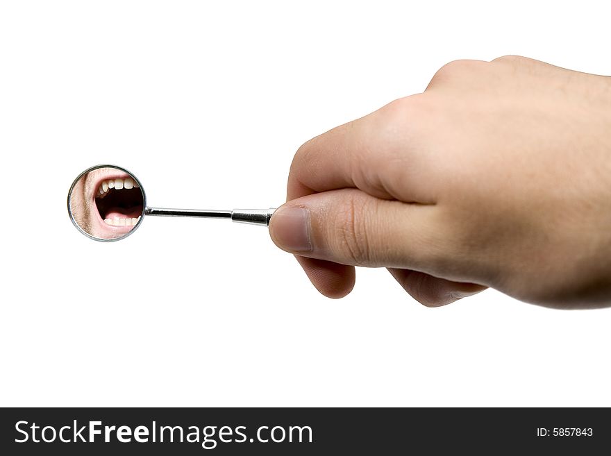 Dental checkup - hand holding speculum (mirror) and look on teeth