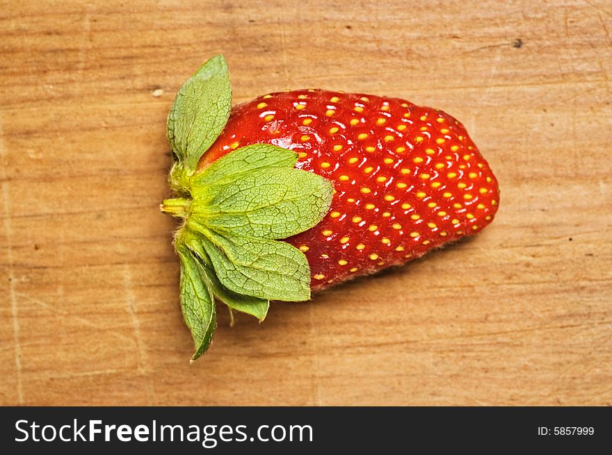 Fresh and tasty strawberrie isolated on wooden background. Fresh and tasty strawberrie isolated on wooden background