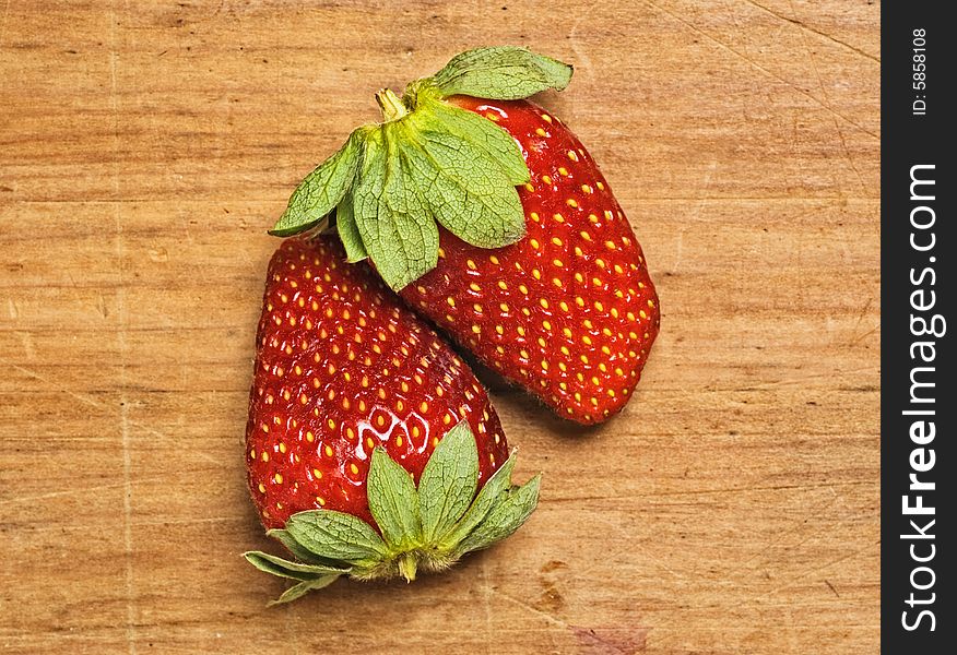 Fresh and tasty strawberries isolated on wooden background. Fresh and tasty strawberries isolated on wooden background