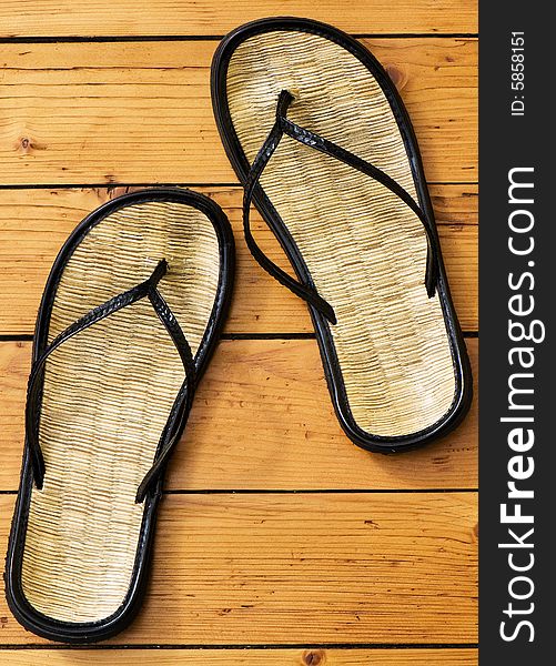 Summer sandals on wooden floor