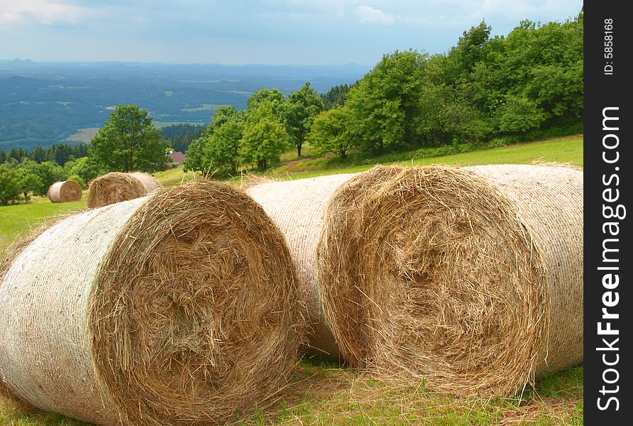 Harvested mountain field in the background view of the valley.