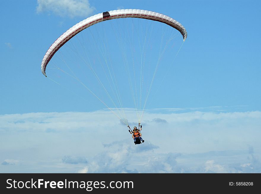 Tandem paragliding in cloudscape area
