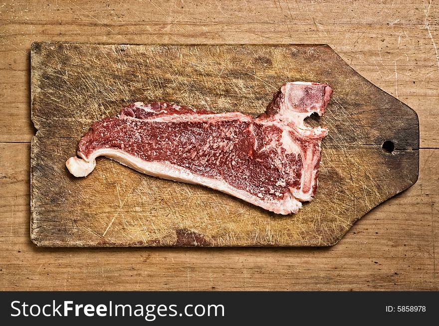 Raw beef steak on cutting table, studio shot. Raw beef steak on cutting table, studio shot.